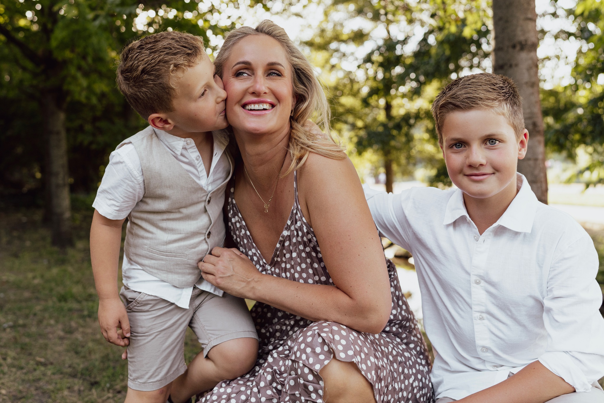 Mother sitting between her children, embracing them.