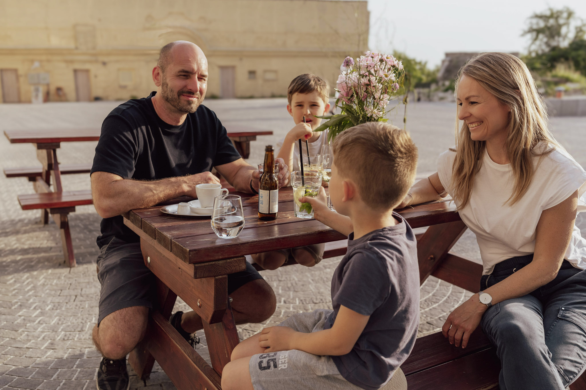 Family sitting at a table with a glass of wine and lemonade.