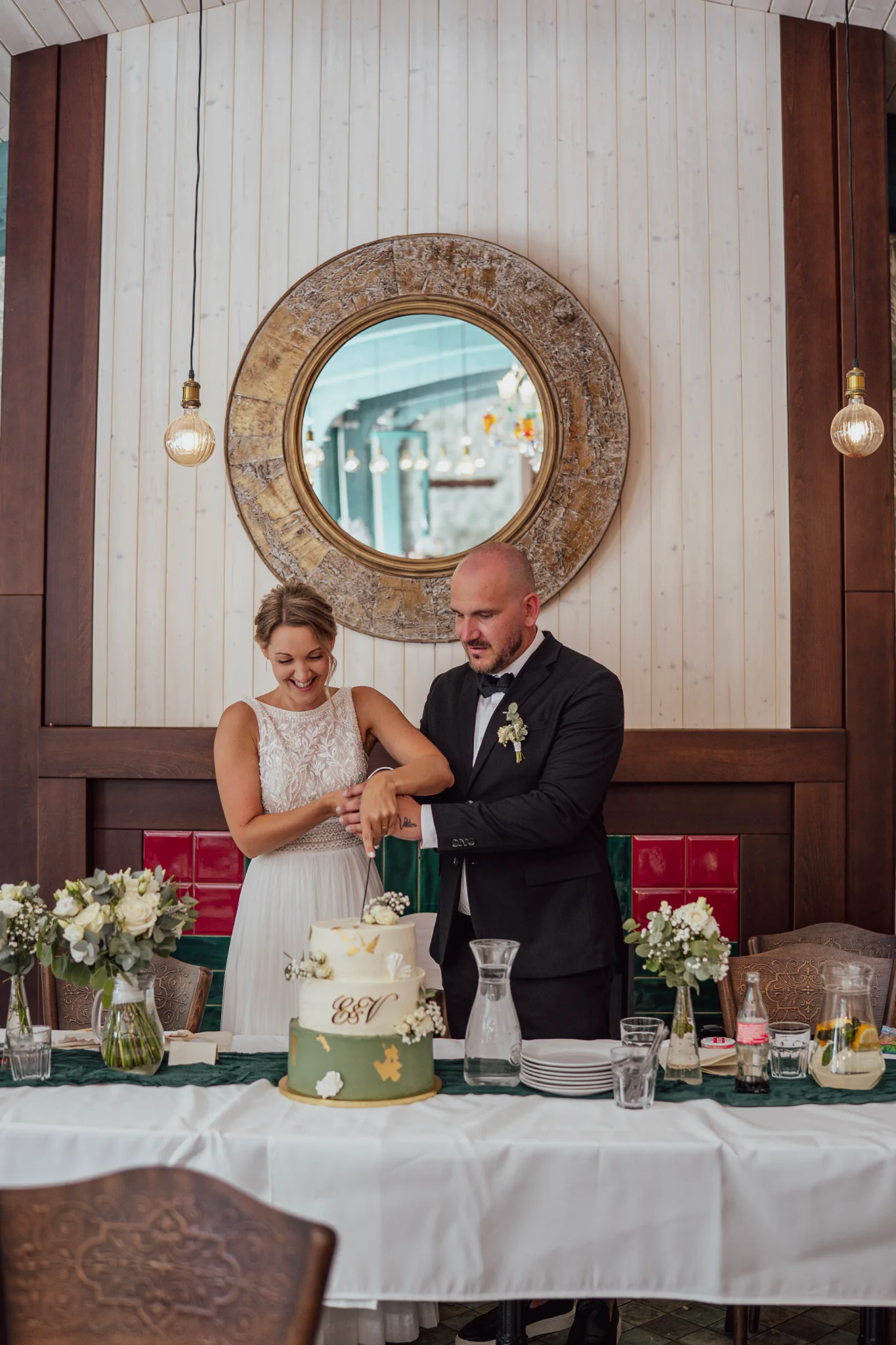 Bride and groom cutting their wedding cake together.