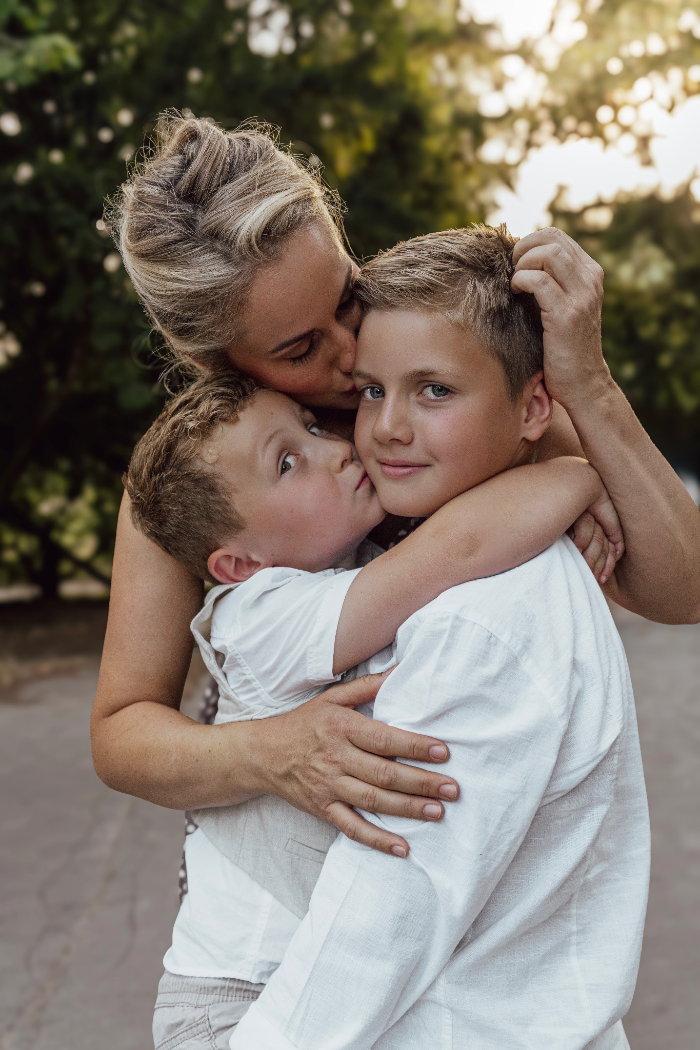 Mother embracing her two young sons.
