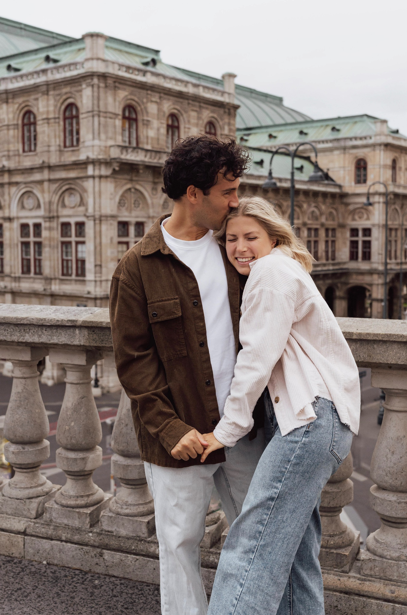 Young couple embracing on the Albertina terrace in Vienna. 